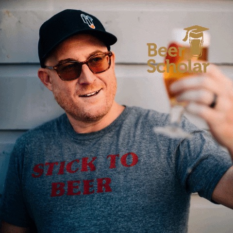 Chris Cohen of Beer Scholar raising a glass of beer